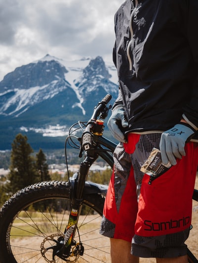 Wearing a black jacket and red pants black riding mountain bike
